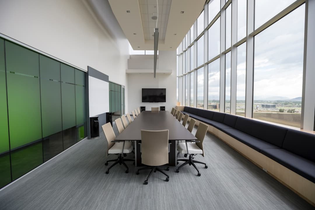 AV technician setting up speakers and a projector screen in a Portland conference room