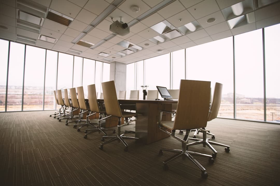 Conference room with projector screen, speaker system, and wireless microphone setup ready for a corporate meeting