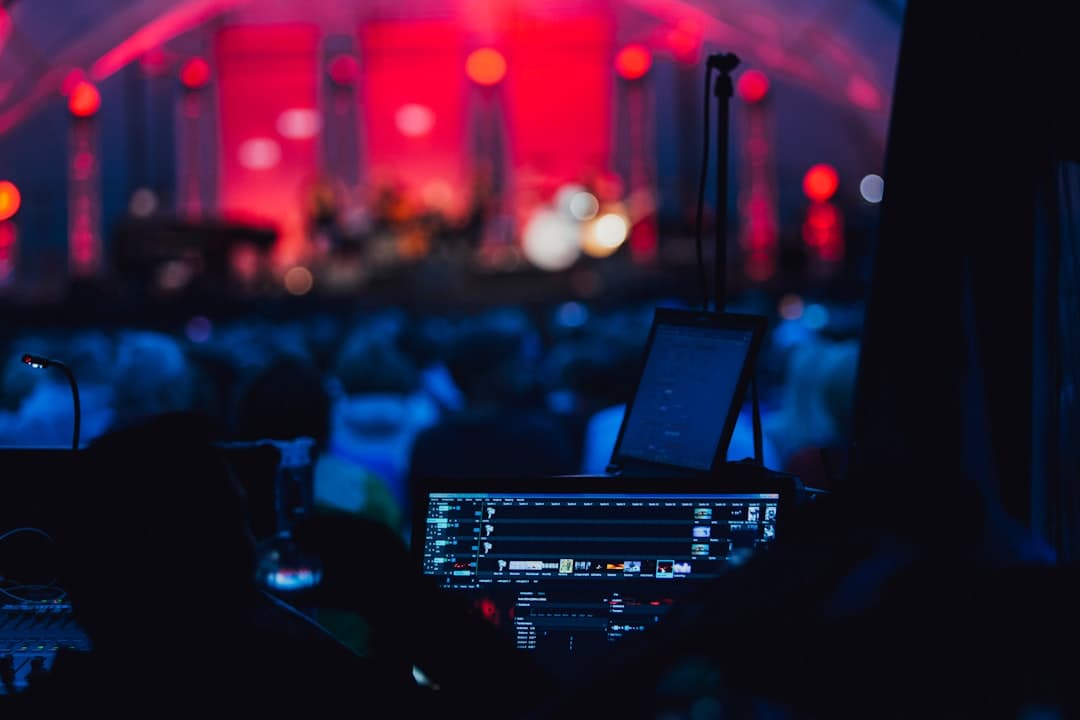 Audio visual equipment being set up in a Portland event venue with speakers, projector, and microphone stand on stage