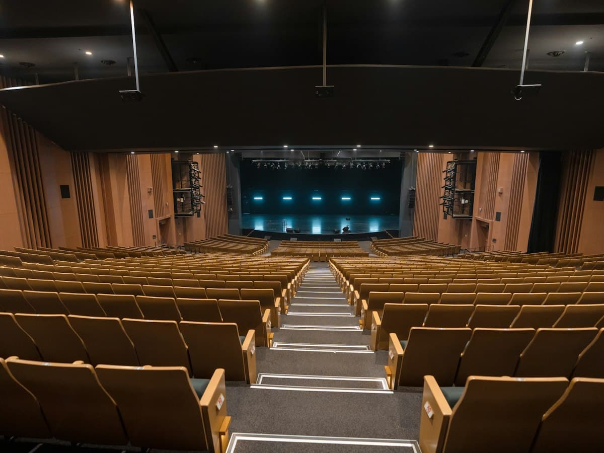 Empty theater with rows of seats and stage - EventGear PDX
