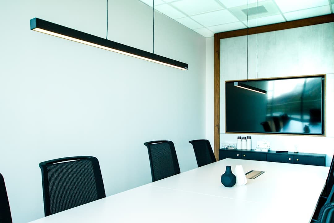 A professional AV setup with projector, screen, and speakers in a conference room
