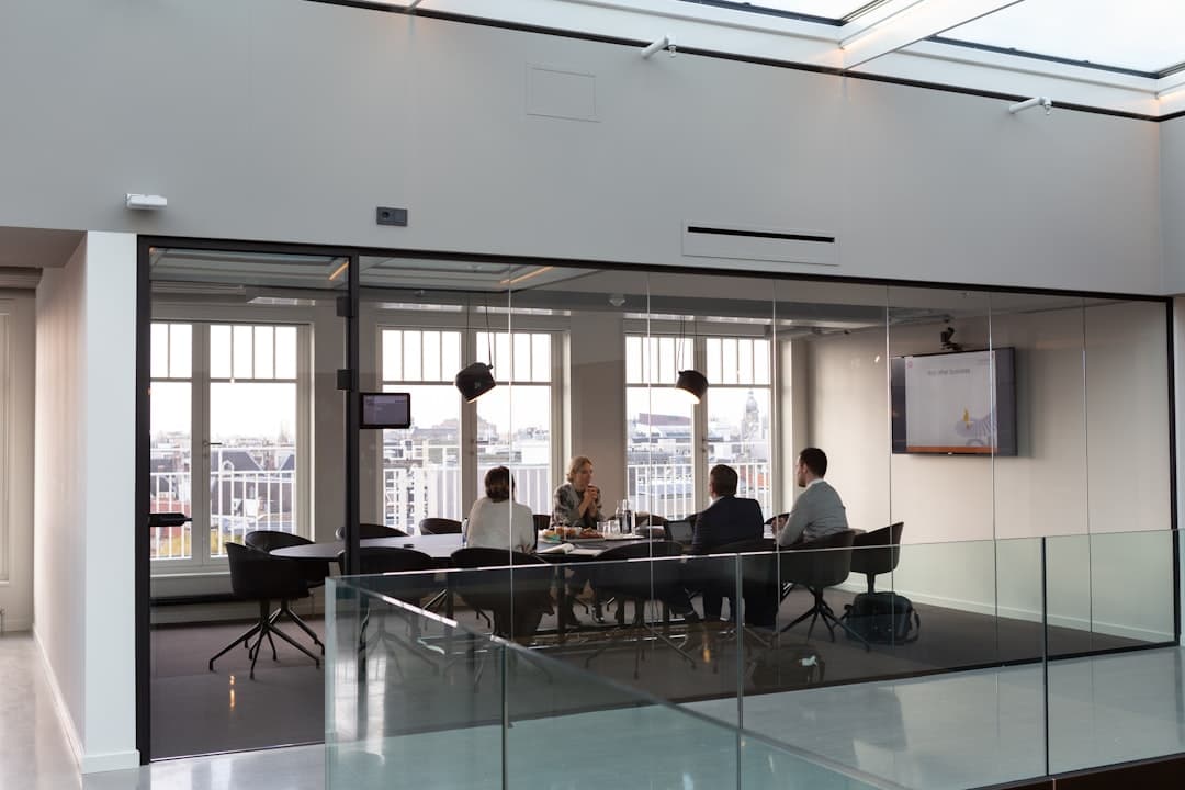 Professional meeting in a well-lit conference room with projection screen and presentation setup