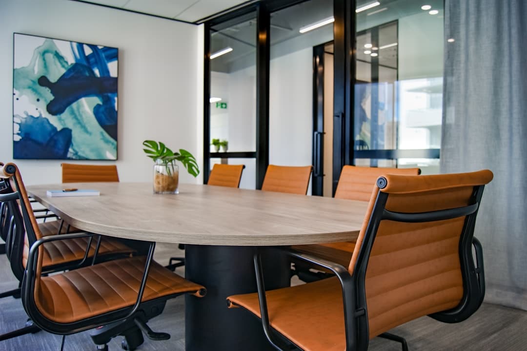 Small corporate meeting room with projector screen and conference table