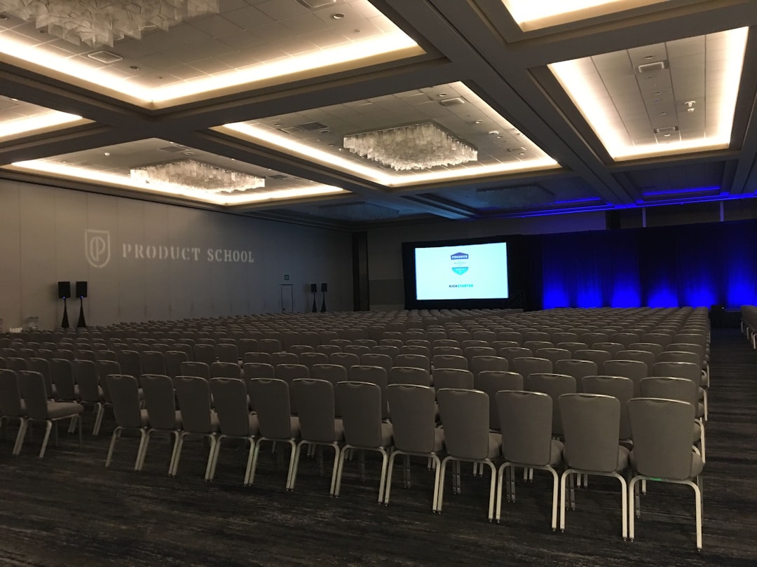 Corporate meeting room with projection screen and podium microphone set up for a presentation