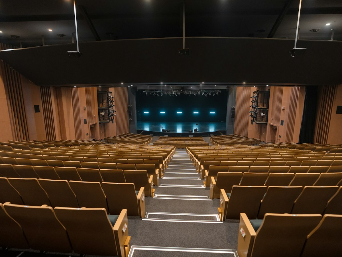 Empty theater with rows of seats and stage - EventGear PDX