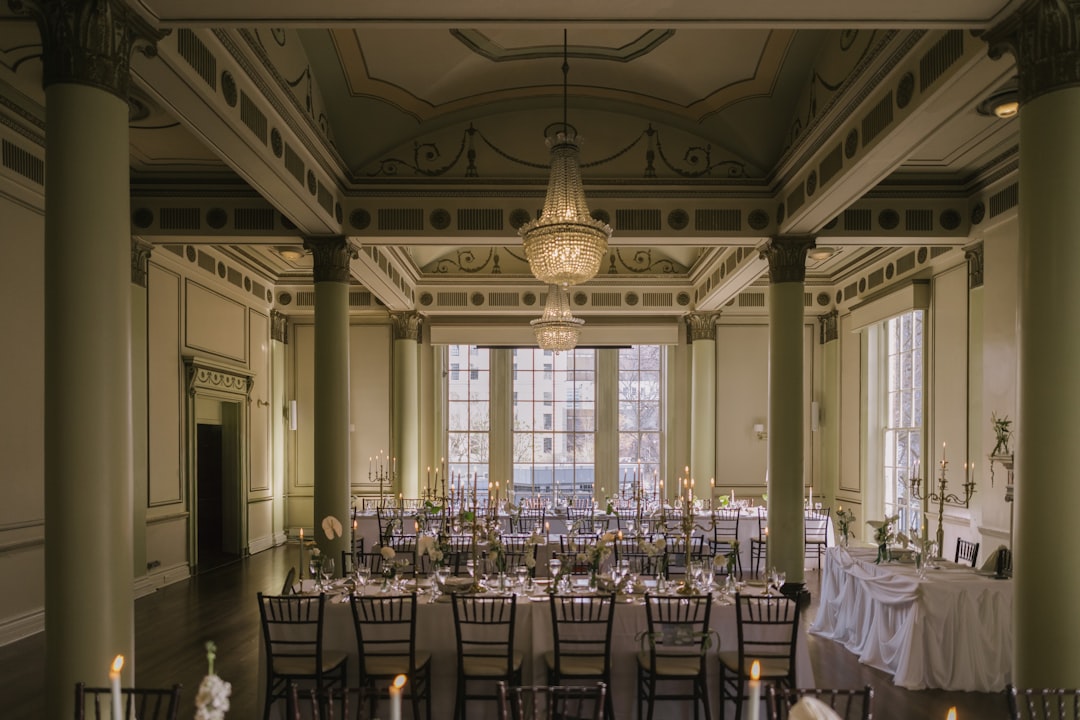 Elegant gala ballroom with projection screen, uplighting, and podium microphone setup